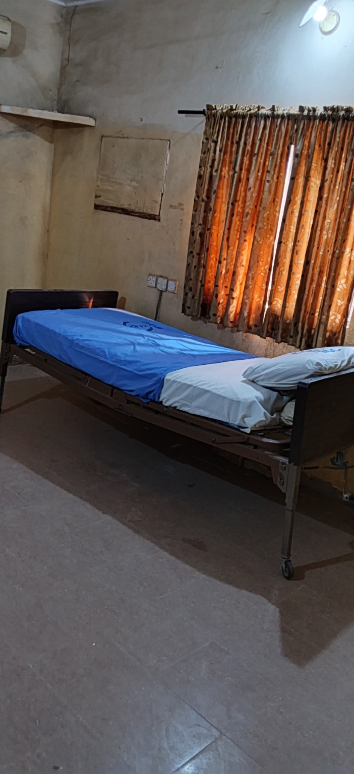 A hospital patient-care room and bed